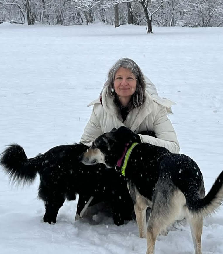 jenn Jennifer Shingler, Treasurer, poses with her two dogs in the snow.