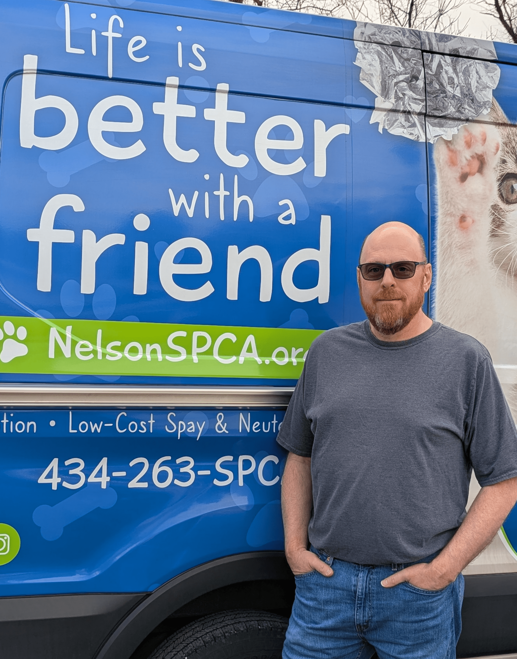 Lance Utley poses for a photo in front of the Nelson SPCA Almost Home van.